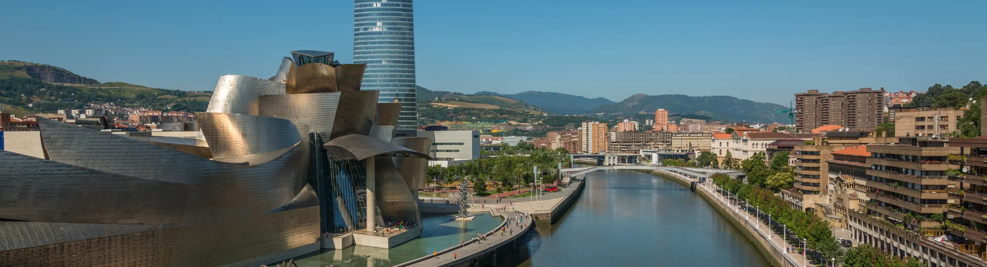 Stedentrip Bilbao Spanje - Bilbao, de grootste stad in het Baskenland in het noorden van Spanje, is een fascinerende stedentripbestemming die zowel cultuur- als natuurliefhebbers zal aanspreken. De stad staat vooral bekend om het iconische Guggenheim Museum, een architecturaal meesterwerk van Frank Gehry dat moderne kunstliefhebbers van over de hele wereld aantrekt. Maar Bilbao heeft veel meer te bieden: van historische wijken zoals het Casco Viejo, met smalle straatjes vol traditionele pintxos-bars, tot de indrukwekkende stadsvernieuwing langs de rivier de Nervión. 