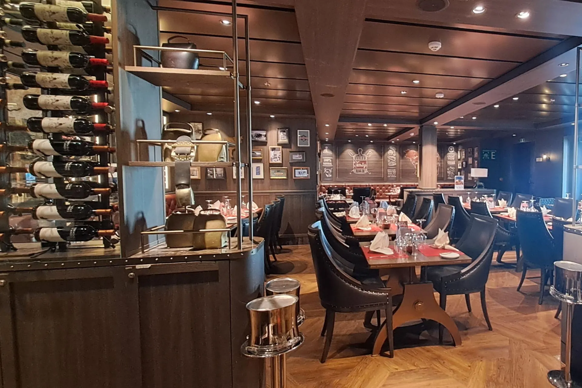 Stijlvol ingericht restaurant met gedekte tafels en flessen wijn op een MSC Cruises schip.