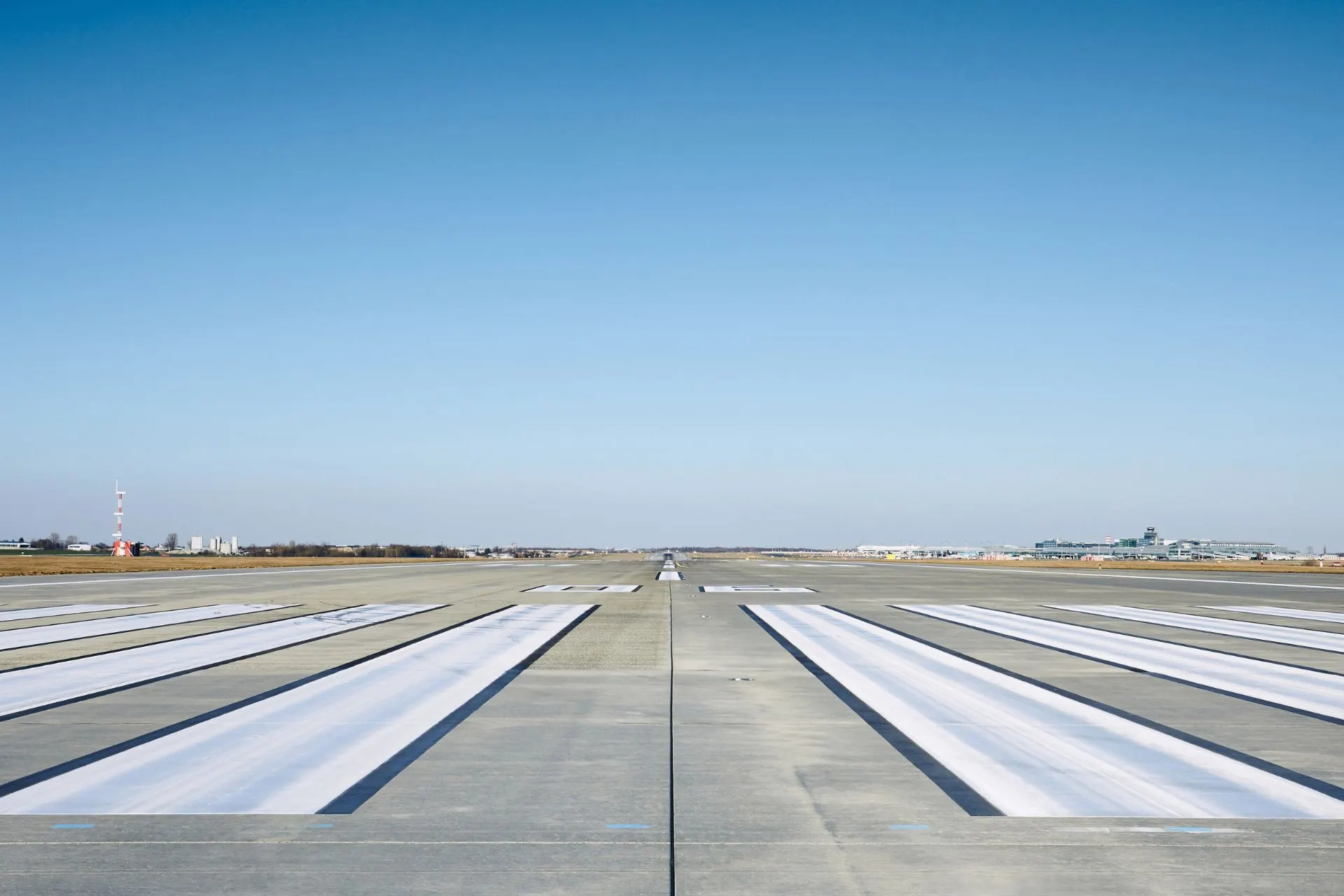 Landingsbaan van luchthaven Luik met blauwe lucht, ideaal voor wie kiest voor vliegen vanaf Luik, comfortabele vluchten vanaf Luik Airport en een vlotte start bij vertrek vanaf luchthaven Luik.