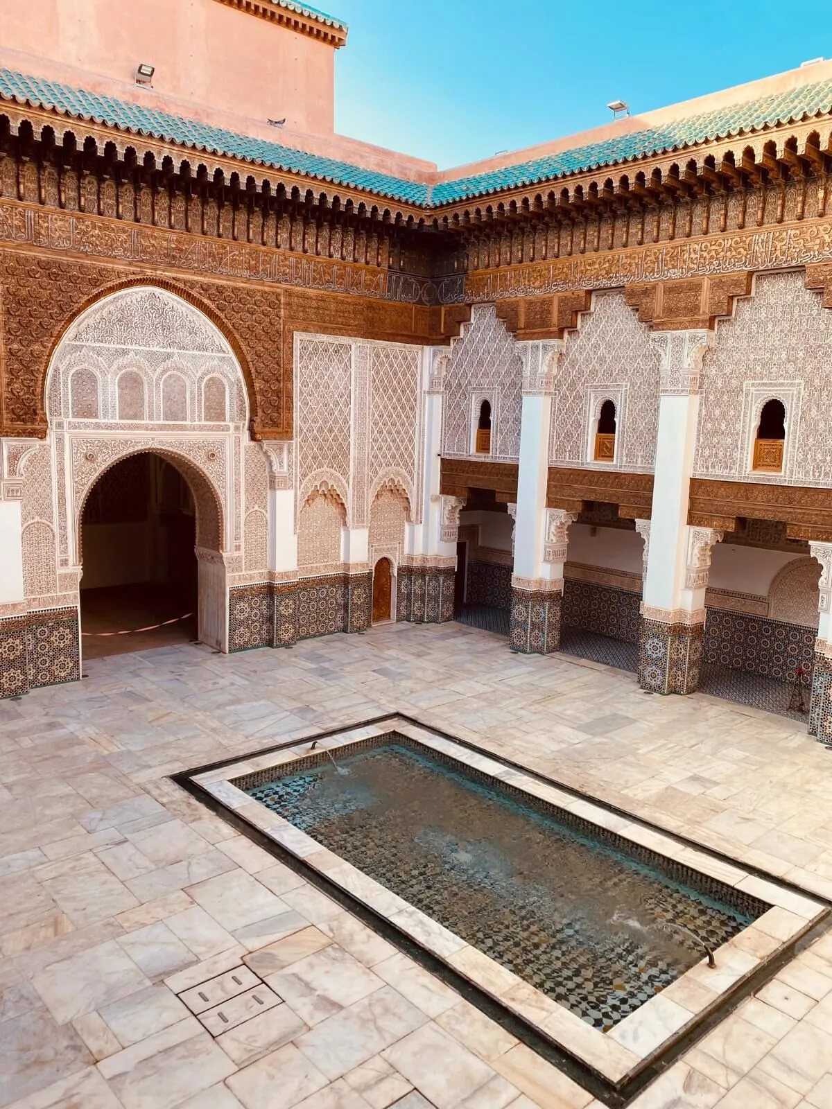 Een prachtig Marokkaans gebouw met gedetailleerde Moorse architectuur, versierd met sierlijke bogen, mozaïektegels en traditionele houten deuren.