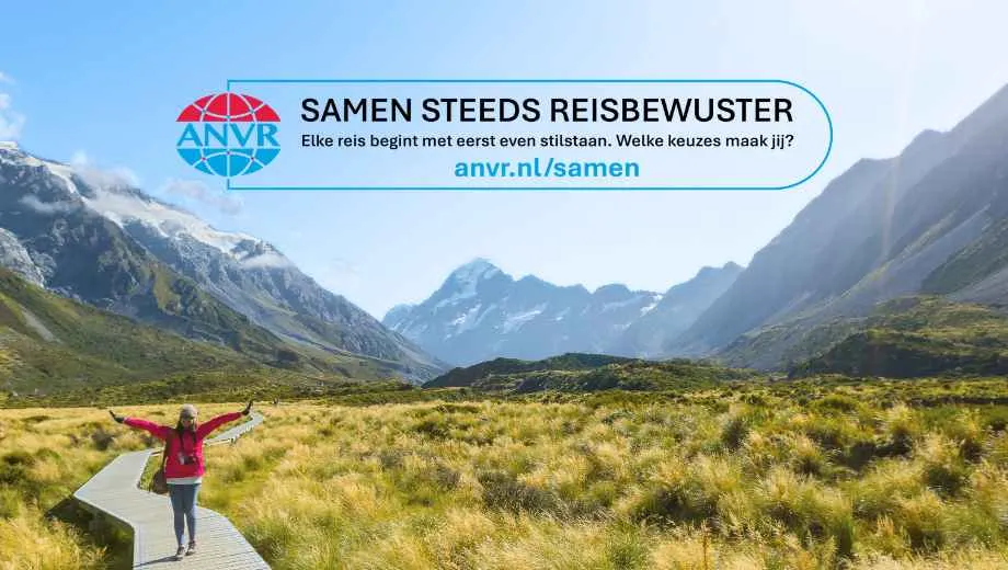 Wandelpad door een uitgestrekt berglandschap met een reiziger in de natuur. Bovenaan staat de ANVR-campagne Samen Steeds Reisbewuster met de tekst: "Elke reis begint met eerst even stilstaan. Welke keuzes maak jij?" en verwijzing naar anvr.nl/samen.