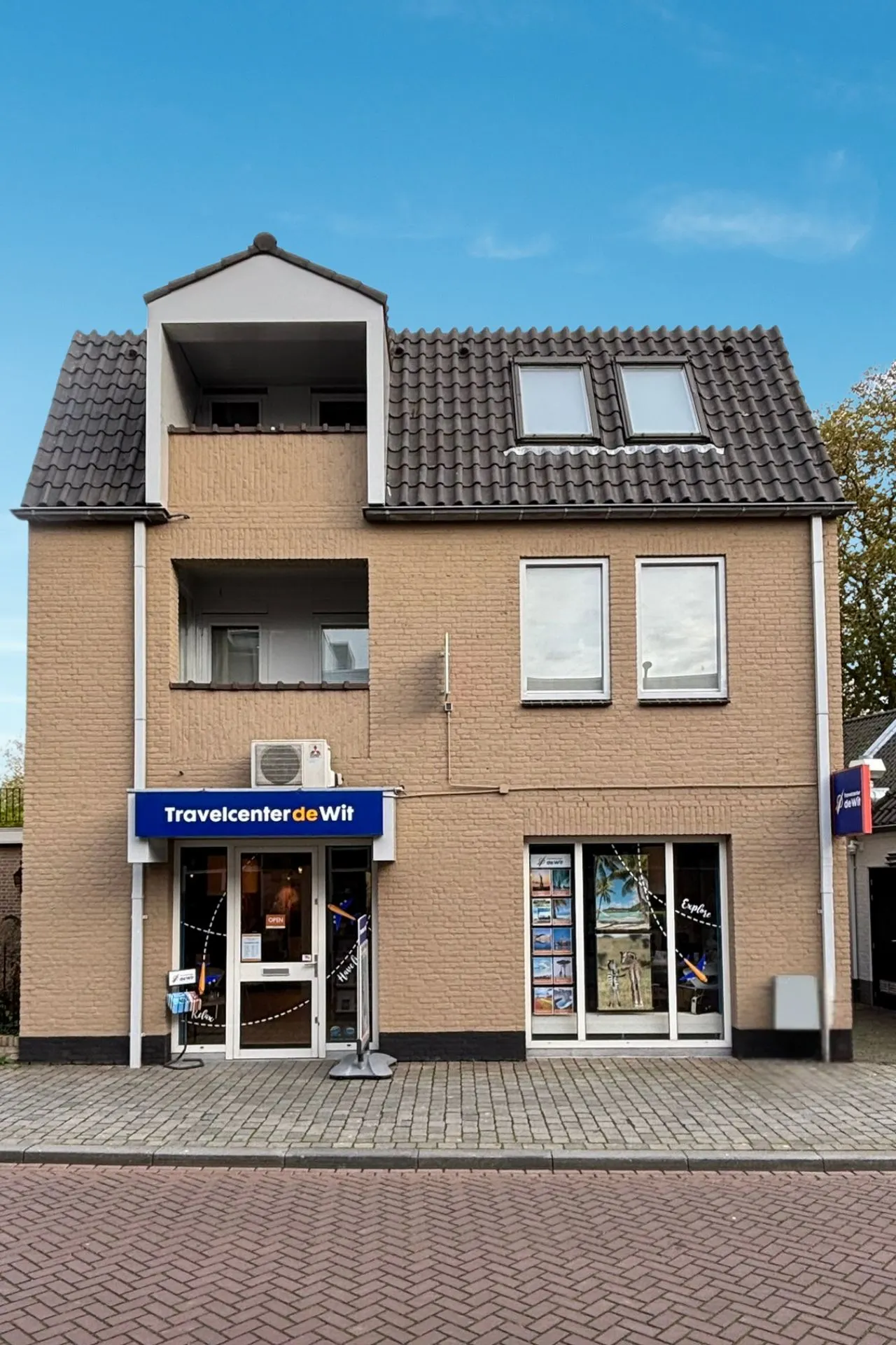 Filiaal Rosmalen van Travelcenter de Wit, rechthoekig gebouw met blauwe lucht.